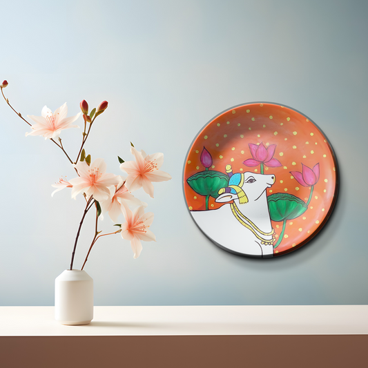 Sacred cow and lotus motif ceramic plate design on wall